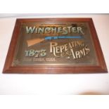 TWO ITEMS - A WINCHESTER ADVERTISING MIRROR, 37 X 54 CM AND A WINCHESTER FRAMED ADVERT 51 X 38 CM