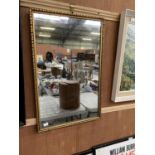 A GILT FRAMED RECTANGULAR MIRROR