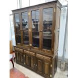 A LARGE SOLID OAK CABINET WITH THREE LOWER DOORS AND DRAWERS AND FOUR UPPER GLAZED DOORS