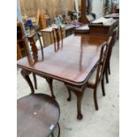 A MAHOGANY EXTENDING DINING TABLE AND FOUR HIGH BACKED DINING CHAIRS