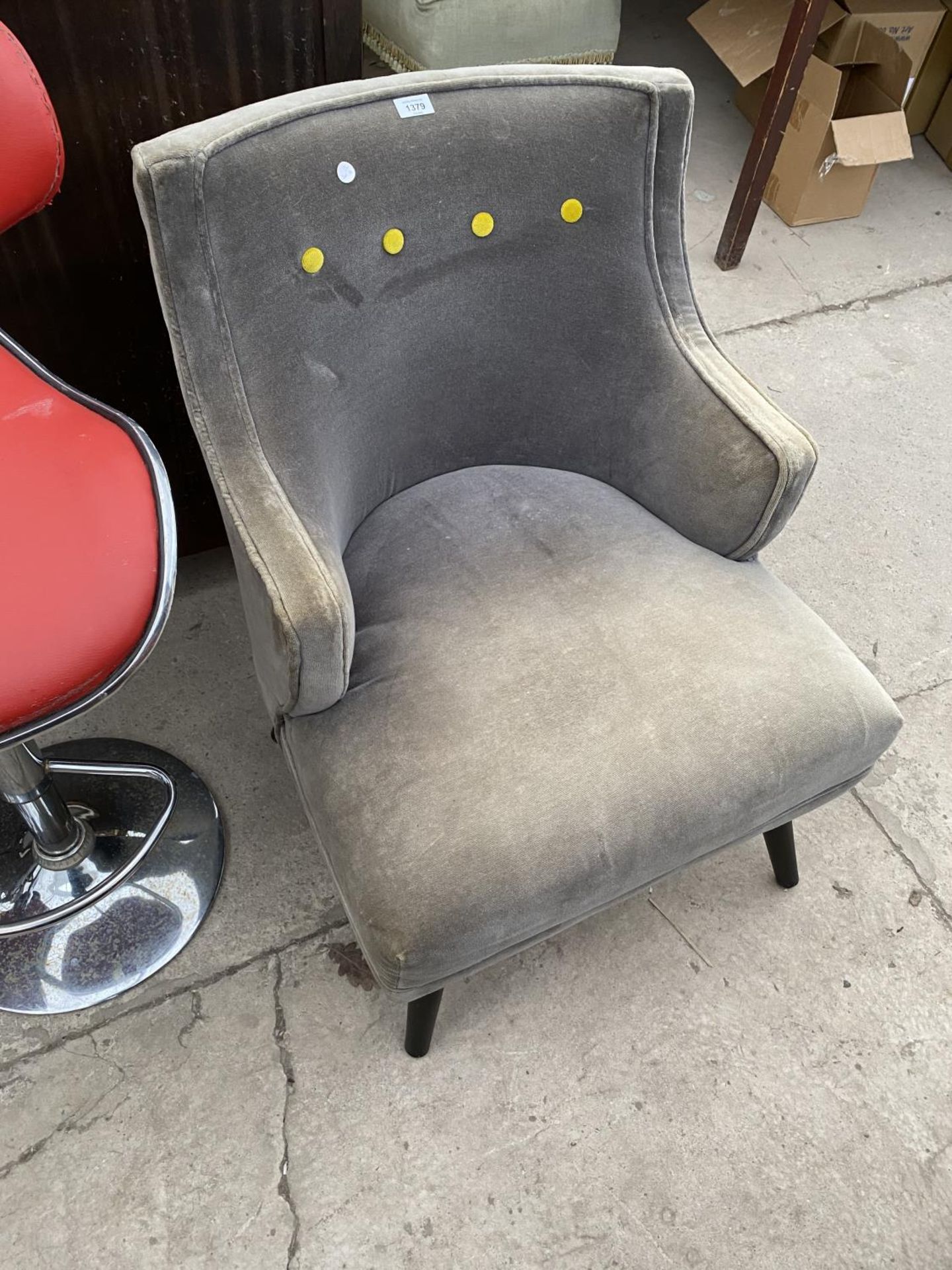 A GREY FABRIC ARMCHAIR