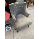 A GREY FABRIC ARMCHAIR