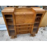 AN OAK SIDE BY SIDE CABINET WITH FALL FRONT, THREE DRAWERS AND TWO GLAZED DOORS