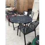 A LARGE CIRCULAR BLACK METAL GARDEN TABLE WITH THREE MATCHING CHAIRS