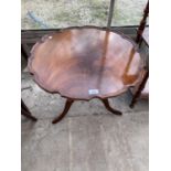 A MAHOGANY OCCASIONAL TABLE WITH PIE CRUST EDGE