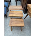 A RETRO TEAK NEST OF THREE TABLES