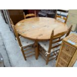 A CIRCULAR PINE DINING TABLE AND FOUR PINE DINING CHAIRS WITH RUSH SEATS