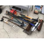 A LARGE COLLECTION OF TOOLS TO INCLUDE FORK, BRUSHES, SHOVEL,RAKE, PICK AXE, PETROL CAN ETC