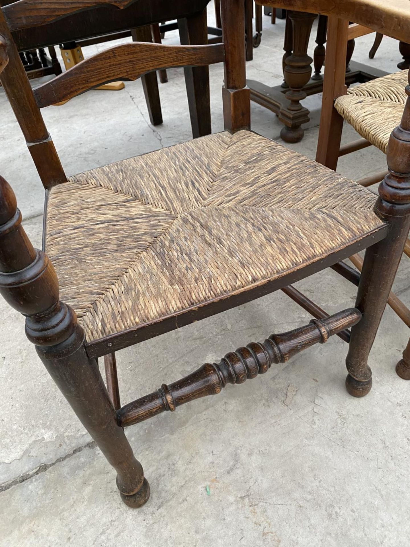 TWO LADDER BACK CARVER DINING CHAIRS WITH RUSH SEATS - ONE OAK, ONE MAHOGANY - Image 3 of 5