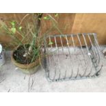 A VINTAGE METAL HAY RACK AND A PLANTER