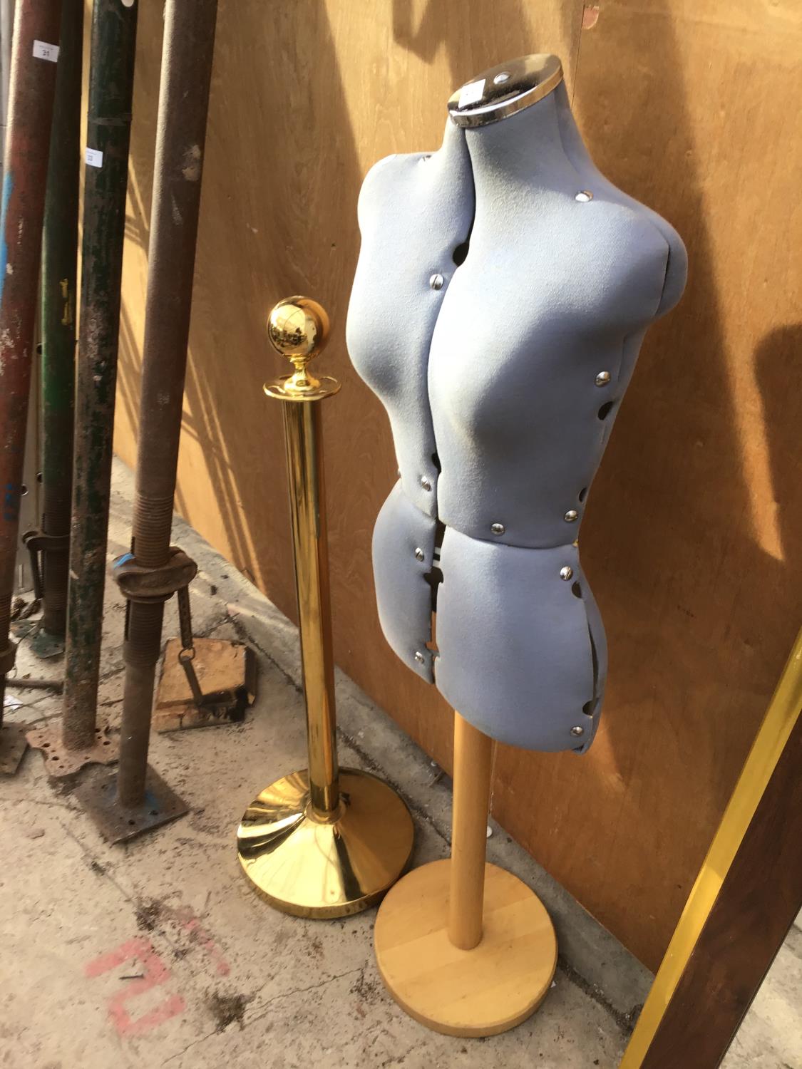 A TAILORS DUMMY AND A BRASS EFFECT DISPLAY STAND