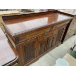 A MAHOGANY SIDEBOARD WITH FOUR DOORS AND THREE DRAWERS