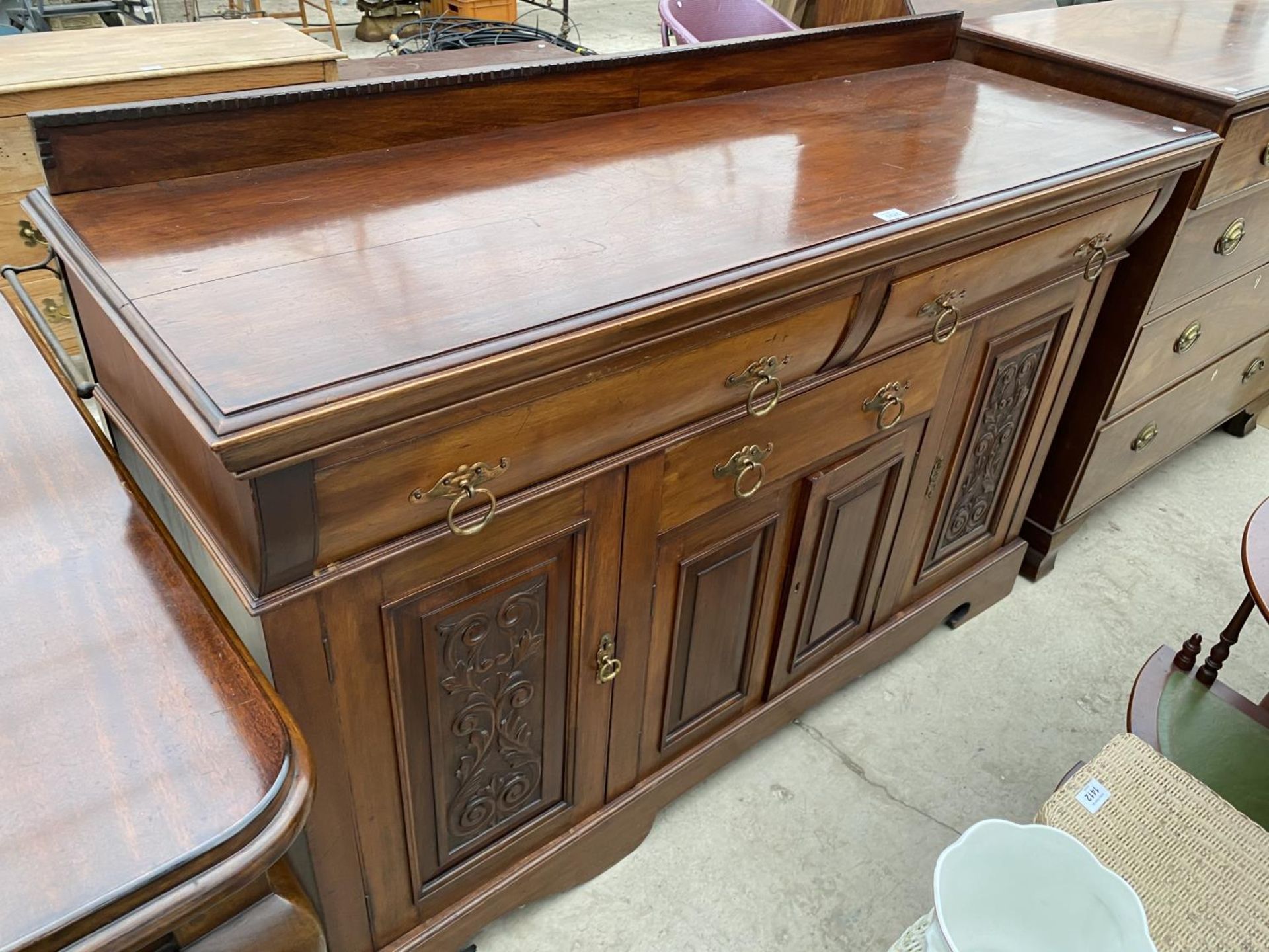 A MAHOGANY SIDEBOARD WITH FOUR DOORS AND THREE DRAWERS