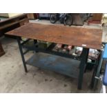 A METAL WORK BENCH WITH LOWER SHELF
