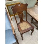 AN OAK BEDROOM CHAIR WITH RATTAN SEAT