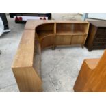 A RETRO TEAK CORNER UNIT WITH SIX LOWER DOORS AND FOUR UPPER SLIDING GLASS DOORS