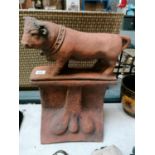 A HEAVY TERRACOTTA EFFECT STONE BULL TWO SECTION ROOF TILE