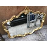 A LARGE ORNATE GILT FRAMED MIRROR