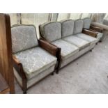 A BERGERE THREE PIECE SUITE WITH A THREE SEATER SOFA AND TWO ARMCHAIRS HAVING RATTAN SIDES AND BACKS