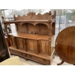 A LARGE OAK SIDEBOARD WITH FOUR DOORS, TWO DRAWERS AND UPPER GALLERIED SHELF