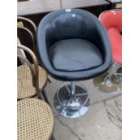 A BLACK BAR STOOL ON CHROME SWIVEL SUPPORT