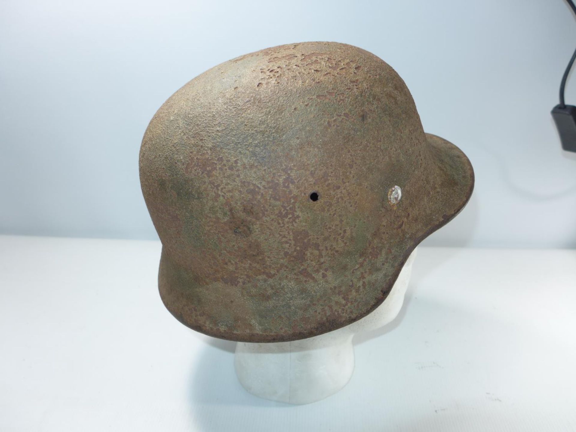 A GERMAN RUSTED AND GREEN PAINTED HELMET - Image 2 of 4