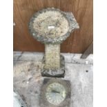 A SUNDIAL ON A CONCRETE BASE AND A CONCRETE BIRD BATH