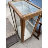 A SMALL PINE PRESENTATION CABINET WITH GLAZED SIDES AND TOP