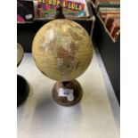 A SMALL DESK GLOBE ON BASE