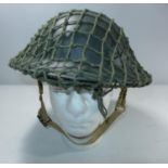 A BRITISH TOMMY HELMET AND NET COVER