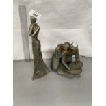 TWO RESIN FIGURINES ONE OF A LADY AND ONE OF MOTHER, FATHER AND CHILD
