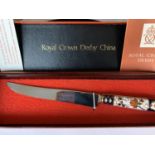 A BOXED ROYAL CROWN DERBY FRUIT KNIFE WITH BONE CHINA IMARI PATTERN HANDLE AND MAKER'S CERTIFICATE