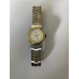 A LADIES EBEL SWISS WRISTWATCH WITH 18 CARAT GOLD BEZEL PEARLESCENT DIAL, GOLD HANDS, DIAMOND DOT