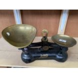 A SET OF VINTAGE BOOTS WEIGHING SCALES WITH BRASS PANS