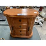 A PINE OVAL JEWELLERY BOX WITH OPENING LID, THREE DRAWERS AND TWO SIDE SECTIONS 26CM TALL
