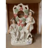 A STAFFORDSHIRE CERAMIC FIGURE OF A LADY AND GENT WITH SPANIEL POCKET WATCH STAND