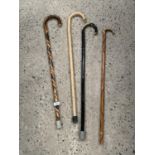 FOUR VARIOUS WALKING STICKS TO INCLUDE A TWIST CARVED EXAMPLE