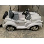 A CHILDS BATTERY OPERATED CAR IN WORKING ORDER WITH CHARGER