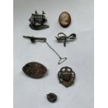 SEVEN MARKED SILVER BROOCHES WITH SHIELD, GALLEON, BOW, CAMEO STYLES ETC