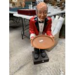 A LARGE RESIN MODEL OF A WAITER IN A RED JACKET AND BOW TIE HOLDING A TRAY 92 CM (3FT)TALL