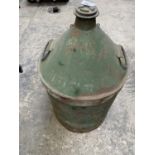 A LARGE VINTAGE GREEN METAL OIL DRUM