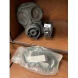 A GAS MASK AND A PAIR OF GOGGLES