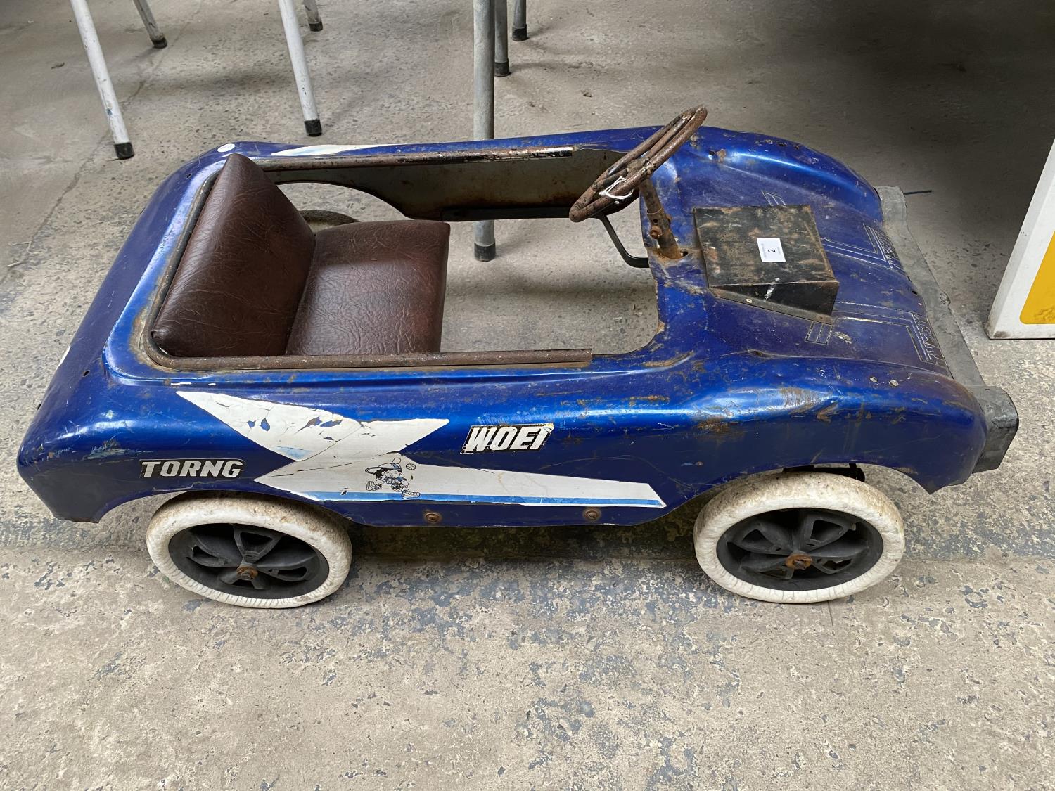 A VINTAGE TORING WOEI CHILDRENS PEDAL RACING CAR IN BLUE