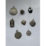 EIGHT MARKED SILVER PENDANTS TO INCLUDE A HEDGEHOG, HEART LOCKET, MALTESE CROSS ETC