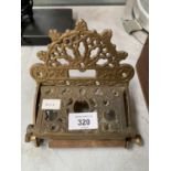 A VINTAGE BRASS ORNATE TOILET ROLL HOLDER