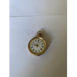 A LADIES T FATTORINI SWISS POCKET WATCH WITH 9 CARAT YELLOW GOLD CASE. WEIGHT 29.7 GRAMS, DIAMETER