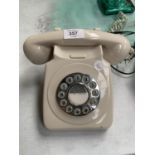 A RETRO CREAM TELEPHONE WITH PUSH BUTTON DIAL WITH WIRE AND PHONE SOCKET PLUG