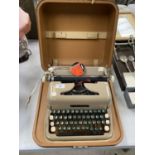 A VINTAGE DIPLOMAT TYPEWRITER IN A CASE WITH RIBBON TIN