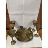 A PERSIAN BRASS DRINKS TRAY WITH FOUR SMALL GOBLETS AND FURTHER SET OF FIVE BRASS WINE GLASSES,