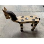 A WOODEN STOOL IN THE FORM OF A HORSE PAINTED IN THE STYLE OF AN APPALOOSA